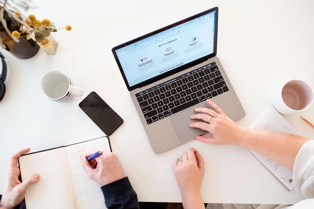 Modern workspace with MacBook Pro, iPhone and notebook